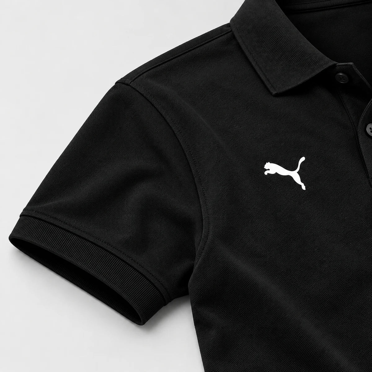 Close-up of the black Apex Crest Polo sleeve cuff, shoulder join and fabric texture